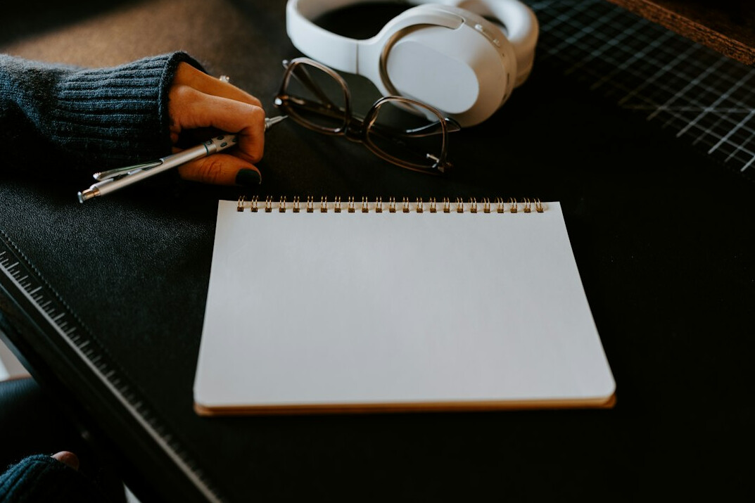 young writer at desk with notebook