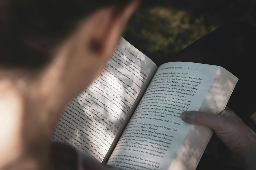 person reading mystery book